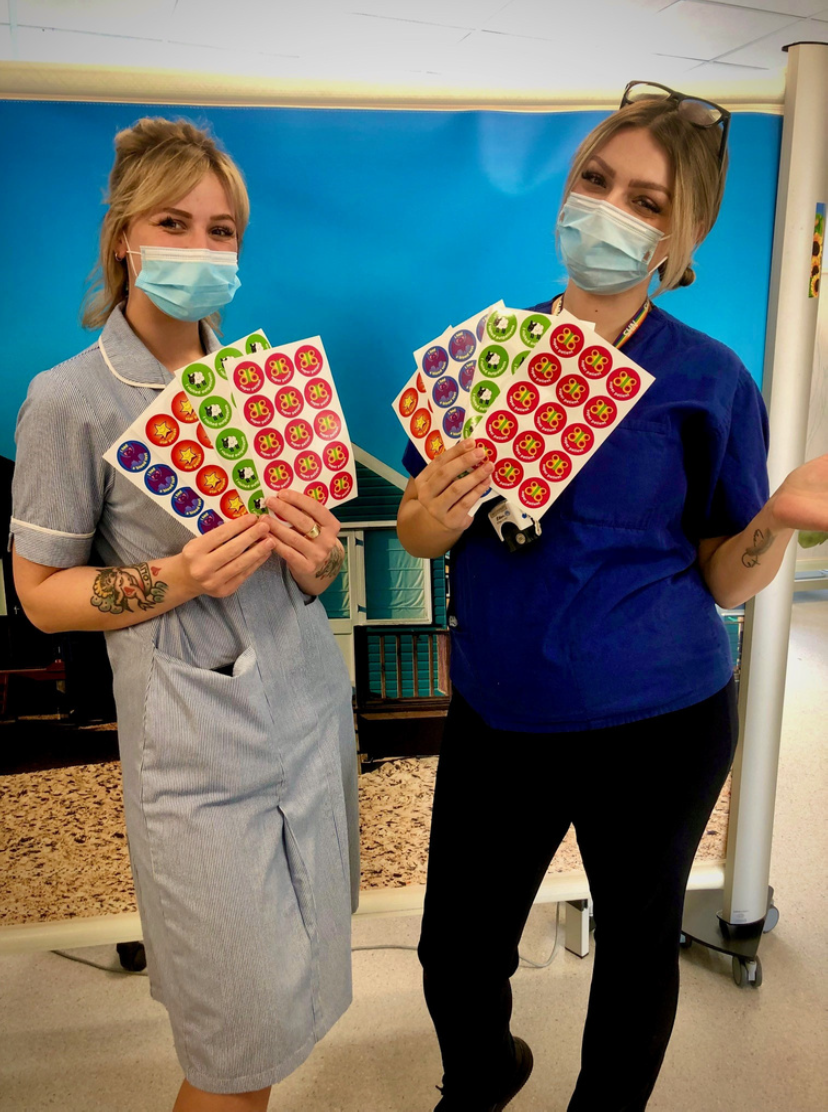 Staff displaying personalised stickers for brave young patients