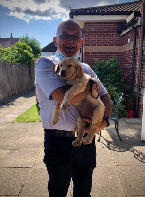 Dr Ram holding therapy puppy Rammie aged 3 months.