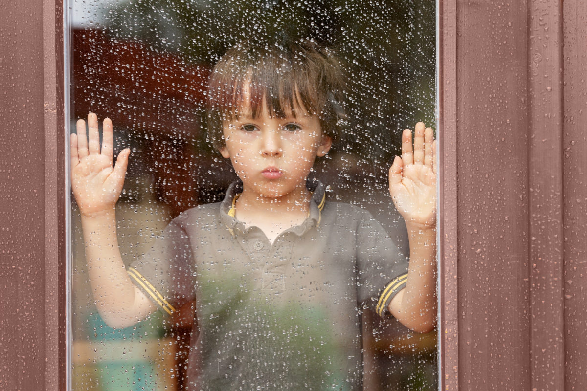 Child looking outside a window