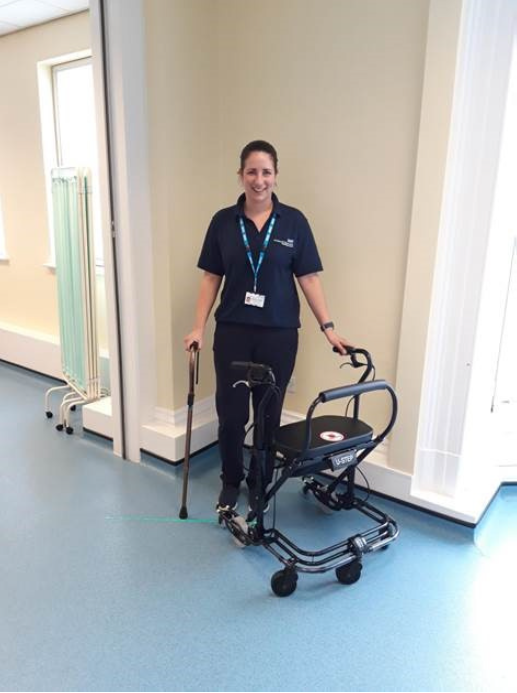 Member of the Parkinson's team modelling the new walking aids purchased with charitable funds