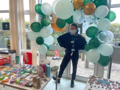 Girl stood infront of balloons