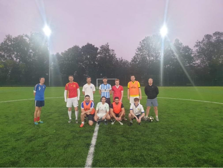Staff football team posing for photo at their monday night gathering